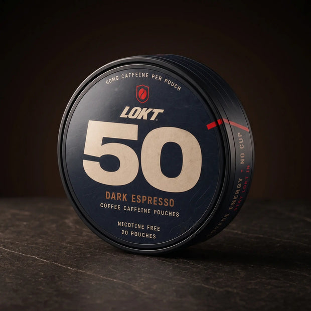 LOKT 50 Dark Espresso caffeine pouch tin, three-quarter view on dark stone. The lid reads nicotine free, 20 pouches.