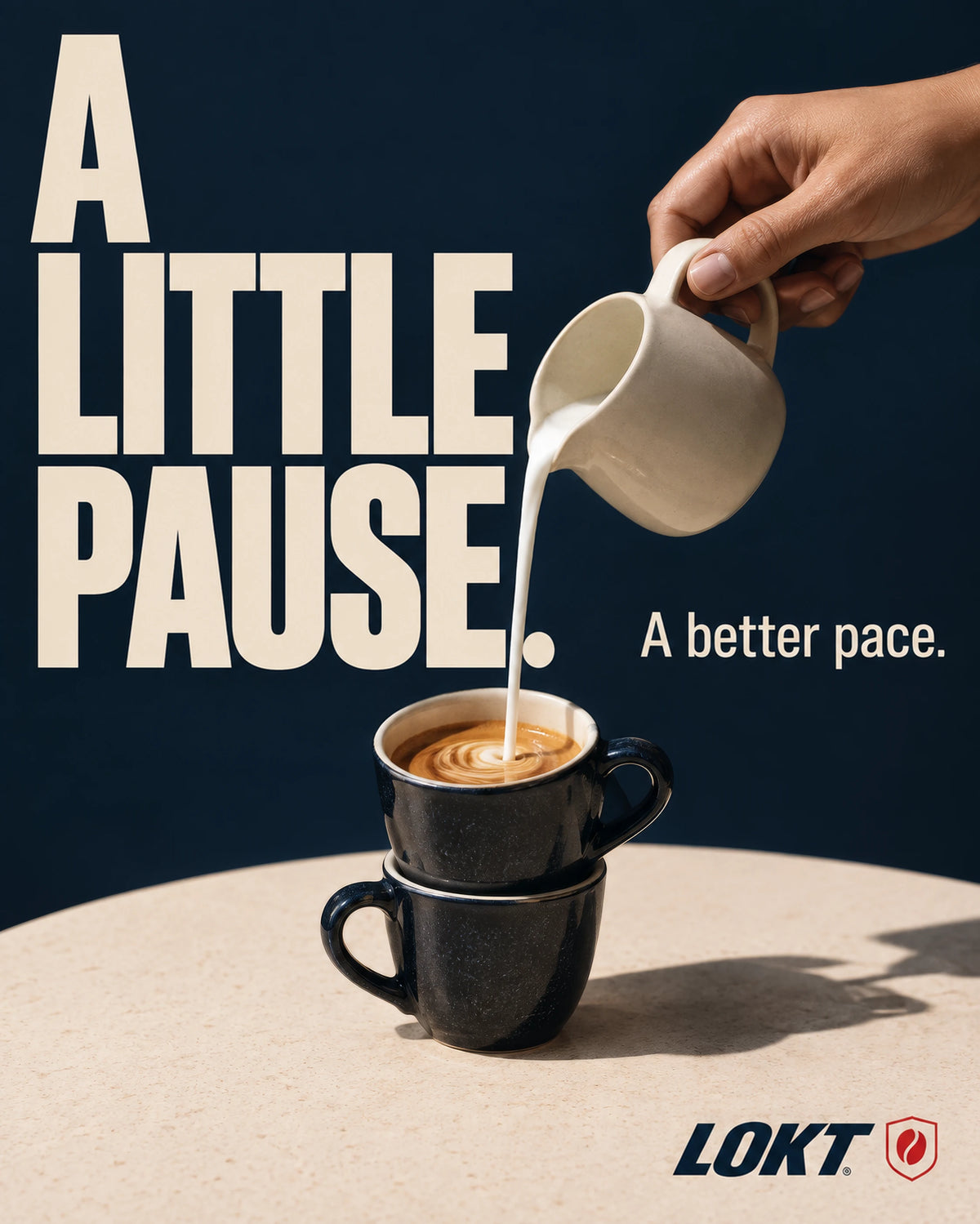 Milk poured into a stacked espresso cup on a stone table, with the words A little pause. A better pace