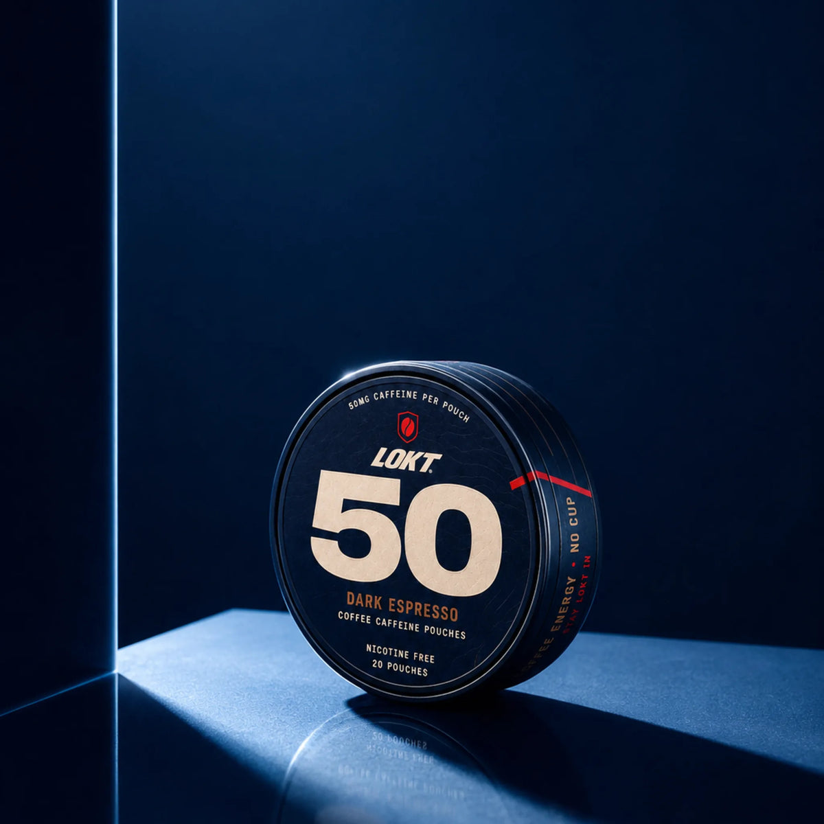 LOKT 50 Dark Espresso tin in a shaft of light on navy