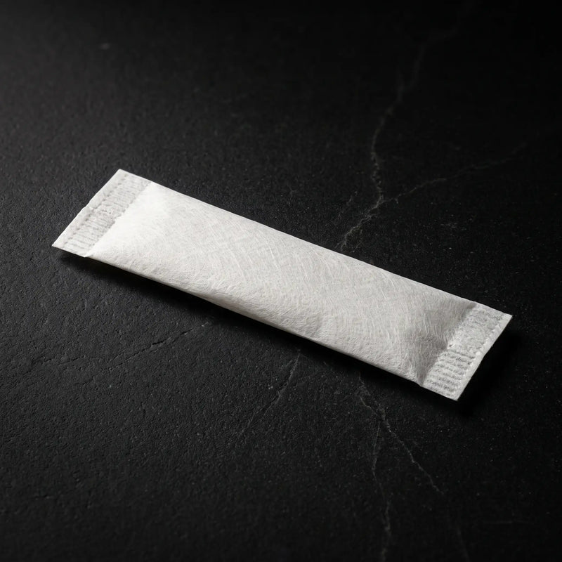 A single LOKT 50 nicotine-free coffee caffeine pouch on a dark surface