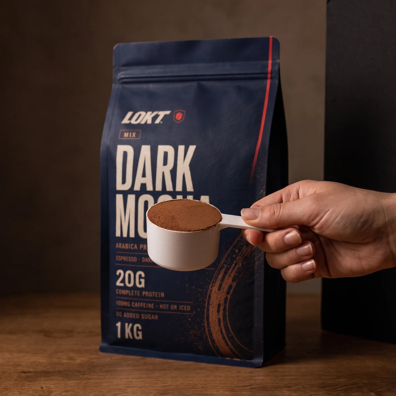 One level 36g scoop of LOKT MIX Dark Mocha held beside the 1kg bag for scale